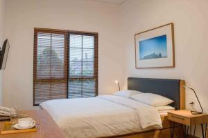 A bed or beds in a room at Rumanami Residence