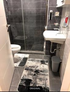 a bathroom with a shower and a sink and a toilet at Lux 05 in Lukavica +36 photos