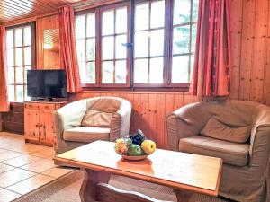 ein Wohnzimmer mit zwei Stühlen und einem Tisch in der Unterkunft Apartment Rousserolles rez gauche by Interhome in Verbier