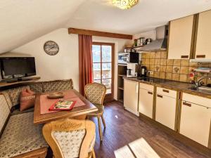 a kitchen and dining room with a table and chairs at Apartment Haflingerhof Edelweiß by Interhome in Kaunertal