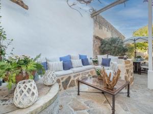 a living room with a couch and a table at Holiday Home Sa Teulera by Interhome in Campanet