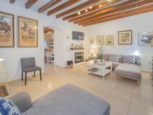 a living room with a couch and a table at Holiday Home Sa Teulera by Interhome in Campanet