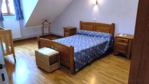 a bedroom with a bed and a wooden floor at Le presbytere in Douzy +34 photos