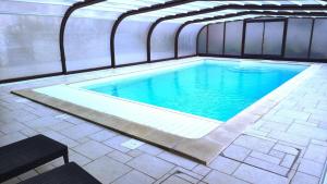 a large swimming pool in a building at Le presbytÈre in Douzy