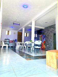 a room with tables and chairs in a building at Jebel Hotel & Lounge Buloba in Kampala