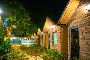 a row of houses at night with lights at MoCha House in Làng Môn