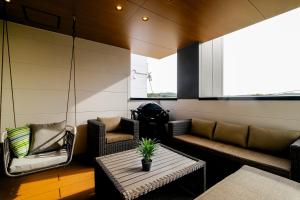 a living room with couches and a table at MIRATIO Sirius in Onna