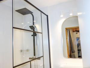 a bathroom with a mirror and a sink at Apartment Nazca I6 by Interhome in Val Thorens
