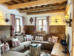 a living room with a couch and a table at Holiday Home st martin chalets-2 by Interhome in Sankt Martin