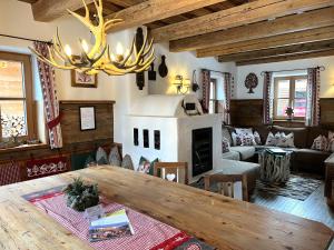 a living room with a table and a fireplace at Holiday Home st martin chalets-1 by Interhome in Sankt Martin +64 photos