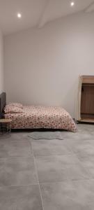 a bed sitting in a room with at Grand Magnifique Studio piscine et parking privé in Manosque