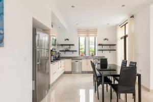 a kitchen with a table and chairs and a refrigerator at Villa Louda in Essaouira