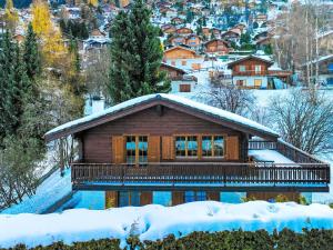 uma cabana de madeira na neve com em Chalet La Couronne by Interhome em Nendaz