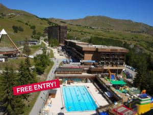 a hotel with a swimming pool and a resort at Studio Soyouz Vanguard-102 by Interhome in Le Corbier