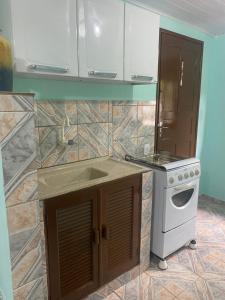 a kitchen with a stove and a counter top at Casa da Inês in Santa Teresa +6 photos