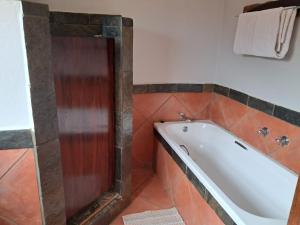 a bathroom with a bath tub in a room at Makhato Bush Lodge 17 in Bela-Bela