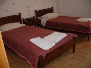 Postel nebo postele na pokoji v ubytování Hotel Inomaos
