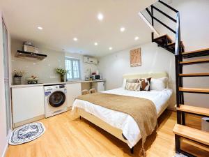 a bedroom with a bed and a staircase at HuaJian in Shanghai