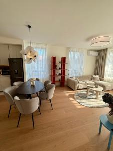a living room with a table and chairs at Aglaya Tokyo - Luxury 2 Bedroom Apartment in Belgrade