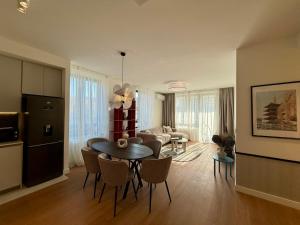 a kitchen and living room with a table and chairs at Aglaya Tokyo - Luxury 2 Bedroom Apartment in Belgrade +16 photos