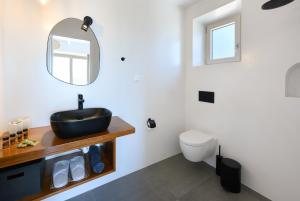 a bathroom with a sink and a toilet at Villa Porto Mongonisi in Porto Ozias +37 photos