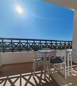 a table and chairs on a balcony with the view of the ocean at Sagres Time Apartamentos in Sagres