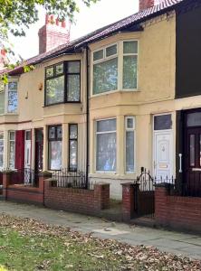 a brick house with windows and a white door at Spacious Home - Sleeps 5 persons - Minutes Walk from Anfield Stadium in Liverpool