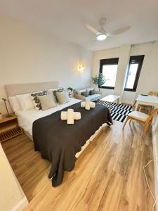 una camera da letto con un letto grande con due asciugamani sopra di Triana Confort Sevilla a Siviglia