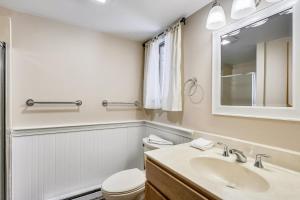 a bathroom with a toilet and a sink and a mirror at Hemlock Ridge 6A in Killington