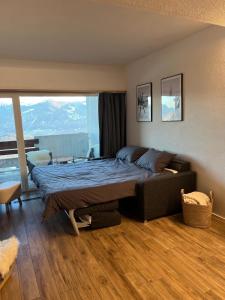 安塞热Studio élégant rénové avec vue à Anzère的一间带床和大窗户的卧室