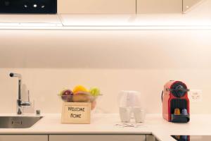 a kitchen counter with a bowl of fruit and a kitchen appliance at HITrental Town Hall Apartments in Basel