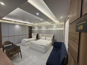 a room with a bed and a couch in it at Hotel Lata Continental in Kānpur