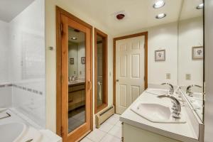 a bathroom with two sinks and a shower at Colony Club C12 in Killington +20 photos