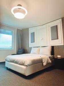 A bed or beds in a room at F Hotel 24h Check-In