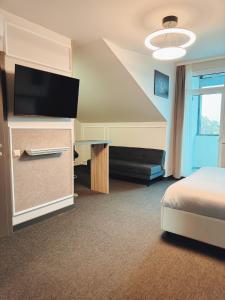 A television and/or entertainment centre at F Hotel 24h Check-In