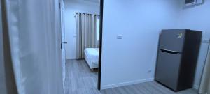 a mirror in a room with a refrigerator at Cocomin Resort in Ban Khao Yai Chum