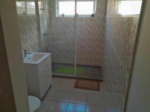 a bathroom with a shower and a toilet and a sink at Hostel Rocha Marisol in Ponta do Sol +16 photos