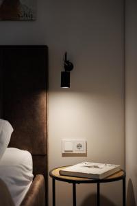 a bedroom with a table next to a bed at P7 Apartments Palanga in Palanga +8 photos