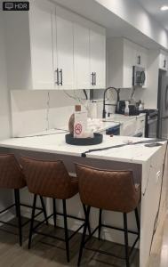 a kitchen with white cabinets and a table with a cake on it at Mixed Rustic Vibes in Chicago