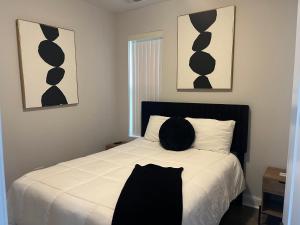 a bedroom with a bed with black and white pillows at Mixed Rustic Vibes in Chicago