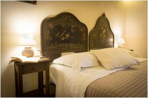 聖韋內里納的住宿－Etna Dependance，一间卧室配有一张大床和一张桌子及书籍