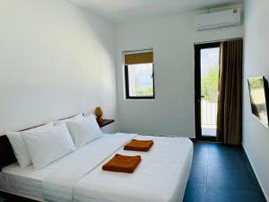 Postel nebo postele na pokoji v ubytování Onederz Kampot