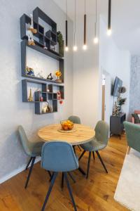 a dining room with a wooden table and chairs at Bjelasnica View Lodge Apartman in Bjelašnica