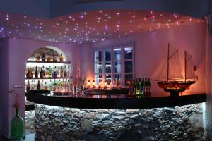 a bar with a pirate ship on the wall at Vrahos Boutique Hotel in Karavostasi