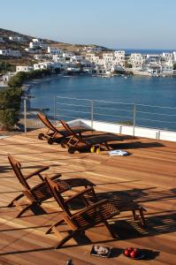a group of chairs sitting on top of a deck at Vrahos Boutique Hotel in Karavostasi