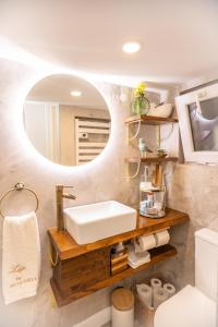 ein Badezimmer mit Waschbecken und Spiegel in der Unterkunft Casa Zen in Azenhas do Mar