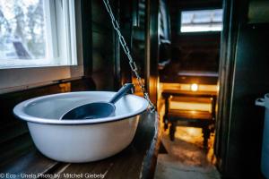 a bath tub chained to a window with a spoon in it at Experience accommadation Eco-Unela in Rovaniemi