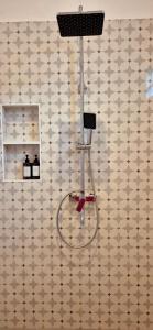 a shower head on a wall in a room at Home Villa in Lovina