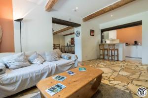 a living room with a couch and a table at Gîte des moulins in Castelnau-dʼEstrétefonds