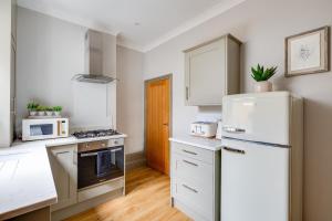 a kitchen with white appliances and a white refrigerator at Royal Chester Retreat - Rose Platinum Properties in Chester +8 photos